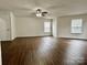 Spacious main bedroom with ceiling fan, hardwood floors and multiple windows at 12713 Frank Wiley Ln, Charlotte, NC 28278