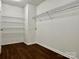 Walk-in closet with sturdy shelving and wood-look flooring at 12713 Frank Wiley Ln, Charlotte, NC 28278