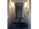 Modern bathroom features a black sink and faucet, a large mirror, and stylish sconces at 1354 Briar Creek Rd, Charlotte, NC 28205