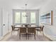 Cozy dining room with natural light, modern chandelier, and stylish decor at 1354 Briar Creek Rd, Charlotte, NC 28205