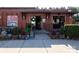 Brewery entrance featuring outdoor seating, greenery, and inviting signage at 1354 Briar Creek Rd, Charlotte, NC 28205