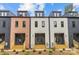 Exterior view of modern townhomes, showcasing their unique architectural design and individual entrances at 1354 Briar Creek Rd, Charlotte, NC 28205