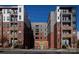 Modern apartment building with brick and gray facade, featuring balconies and ample windows at 1354 Briar Creek Rd, Charlotte, NC 28205
