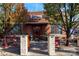 Charming tavern entrance with brick facade, mature trees, and outdoor seating at 1354 Briar Creek Rd, Charlotte, NC 28205