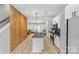 Bright kitchen features an island, white cabinets, and stainless steel appliances, open to the living area at 1354 Briar Creek Rd, Charlotte, NC 28205