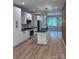 A modern kitchen boasts sleek white cabinetry, black countertops, and stainless steel appliances, all illuminated by stylish pendant lights at 1354 Briar Creek Rd, Charlotte, NC 28205