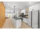 Stylish kitchen with a central island, white cabinets, and stainless steel appliances connected to the living room at 1354 Briar Creek Rd, Charlotte, NC 28205