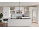Bright, modern kitchen with white cabinetry, stainless steel appliances, and a large island with seating at 1354 Briar Creek Rd, Charlotte, NC 28205