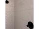 Modern tiled shower with unique geometric texture, and black shower head and faucet at 1354 Briar Creek Rd, Charlotte, NC 28205