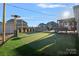 Beautiful backyard with a putting green, outdoor heater, stone fireplace, and plenty of space for outdoor activities at 14004 Fiery Mist Way, Huntersville, NC 28078