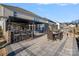Large paved patio with an outdoor kitchen, bar seating, and dining area, perfect for entertaining guests at 14004 Fiery Mist Way, Huntersville, NC 28078