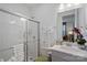 Clean bathroom with glass shower, tile surround, granite vanity, and soft lighting at 14004 Fiery Mist Way, Huntersville, NC 28078