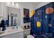 A bathroom with a themed shower curtain, coordinated towels, and a charming, playful aesthetic at 14004 Fiery Mist Way, Huntersville, NC 28078
