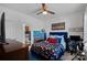 Bright bedroom with blue accents, featuring a bed with patterned bedding and a view of the attached bathroom at 14004 Fiery Mist Way, Huntersville, NC 28078