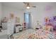 A charming room with bright decor, including a colorful rug, patterned bedspread, and playful decorations at 14004 Fiery Mist Way, Huntersville, NC 28078