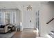 Bright and airy foyer with hardwood floors, a front door, and an adjacent staircase leading to the upper level at 14004 Fiery Mist Way, Huntersville, NC 28078