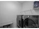 Modern laundry room equipped with new, high-efficiency washer and dryer units at 14004 Fiery Mist Way, Huntersville, NC 28078