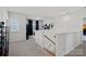 Bright loft area with staircase, white walls, and large windows offering plenty of natural light at 14004 Fiery Mist Way, Huntersville, NC 28078