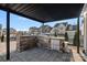 Outdoor kitchen with stone accents, built-in grill, and a view of the landscaped backyard at 14004 Fiery Mist Way, Huntersville, NC 28078