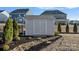 Well-maintained shed with decorative stone and mulch landscaping and mature privacy shrubs at 14004 Fiery Mist Way, Huntersville, NC 28078
