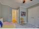 Bright bedroom featuring closet, comfortable bed, and view into hallway with hardwood flooring at 15824 Feeny Ct, Charlotte, NC 28278