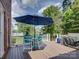 Outdoor deck with a table, chairs, umbrella and grill, great for alfresco dining and entertaining with a view of the lake at 15824 Feeny Ct, Charlotte, NC 28278