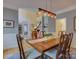 Stylish dining room with seating for six, featuring a view of the staircase and French doors at 15824 Feeny Ct, Charlotte, NC 28278