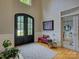 Bright foyer with a decorative rug, stylish bench, and glass-paneled doors to another room at 15824 Feeny Ct, Charlotte, NC 28278