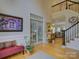 Spacious foyer with staircase, art, and glass-paneled doors, showing an open and inviting layout at 15824 Feeny Ct, Charlotte, NC 28278