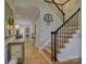 Welcoming foyer showcasing the staircase with black metal railings and warm hardwood floors at 15824 Feeny Ct, Charlotte, NC 28278