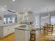 Spacious kitchen featuring granite counters, stainless appliances and island cooktop with bar stool seating at 15824 Feeny Ct, Charlotte, NC 28278