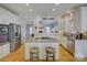 Open kitchen featuring stainless steel appliances, granite counters, and a peninsula with seating at 15824 Feeny Ct, Charlotte, NC 28278