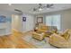 Inviting living room with hardwood floors, ceiling fans, and comfortable leather seating at 15824 Feeny Ct, Charlotte, NC 28278