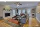 Inviting living room with a cozy fireplace, neutral décor, and abundant natural light at 15824 Feeny Ct, Charlotte, NC 28278
