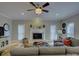 Cozy living room with a fireplace, mantel with decor, and comfortable gray sectional sofa at 15824 Feeny Ct, Charlotte, NC 28278