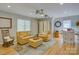 Spacious living room with hardwood floors, ceiling fans, and comfortable seating arrangement at 15824 Feeny Ct, Charlotte, NC 28278