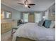 Bright main bedroom featuring neutral decor, a ceiling fan, and soft natural light from the windows at 15824 Feeny Ct, Charlotte, NC 28278