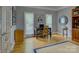 Comfortable office space featuring a wooden desk, chair, hardwood floors, and ample natural light at 15824 Feeny Ct, Charlotte, NC 28278