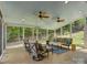 Relaxing sunroom with ceiling fans, comfortable seating, and views of the surrounding landscape provides a great space for entertaining at 15824 Feeny Ct, Charlotte, NC 28278