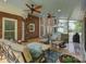 Spacious sunroom with comfortable seating, ceiling fans, and access to the deck creates a relaxing indoor-outdoor living space at 15824 Feeny Ct, Charlotte, NC 28278