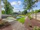 Spacious backyard with a hot tub, patio area, and lush landscaping at 1614 Brook Rd, Charlotte, NC 28205