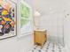 Bright bathroom featuring a wooden vanity, a round mirror, and stylish floor tiles at 1614 Brook Rd, Charlotte, NC 28205