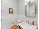 A serene bathroom with white subway tiles, a stylish vanity and wood toilet seat for contrast at 1614 Brook Rd, Charlotte, NC 28205