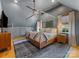 Stylish bedroom featuring a modern four-poster bed, blue accent wall, and hardwood flooring at 1614 Brook Rd, Charlotte, NC 28205