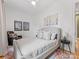 Neutral bedroom with a gray upholstered bed, accent chair and ceiling fan for a calming atmosphere at 1614 Brook Rd, Charlotte, NC 28205