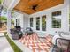 Relaxing covered patio with ceiling fan, comfortable seating, and outdoor grill at 1614 Brook Rd, Charlotte, NC 28205