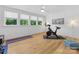 Sunlit exercise room with hardwood floors, large windows, and workout equipment at 1614 Brook Rd, Charlotte, NC 28205