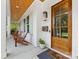 Inviting front porch with wooden ceiling, chairs and a wooden front door at 1614 Brook Rd, Charlotte, NC 28205