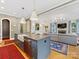 Open concept kitchen features a large island with a farmhouse sink and stainless steel dishwasher at 1614 Brook Rd, Charlotte, NC 28205