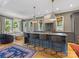 Open-concept kitchen with a large island, bar seating, and views into a bright living space at 1614 Brook Rd, Charlotte, NC 28205